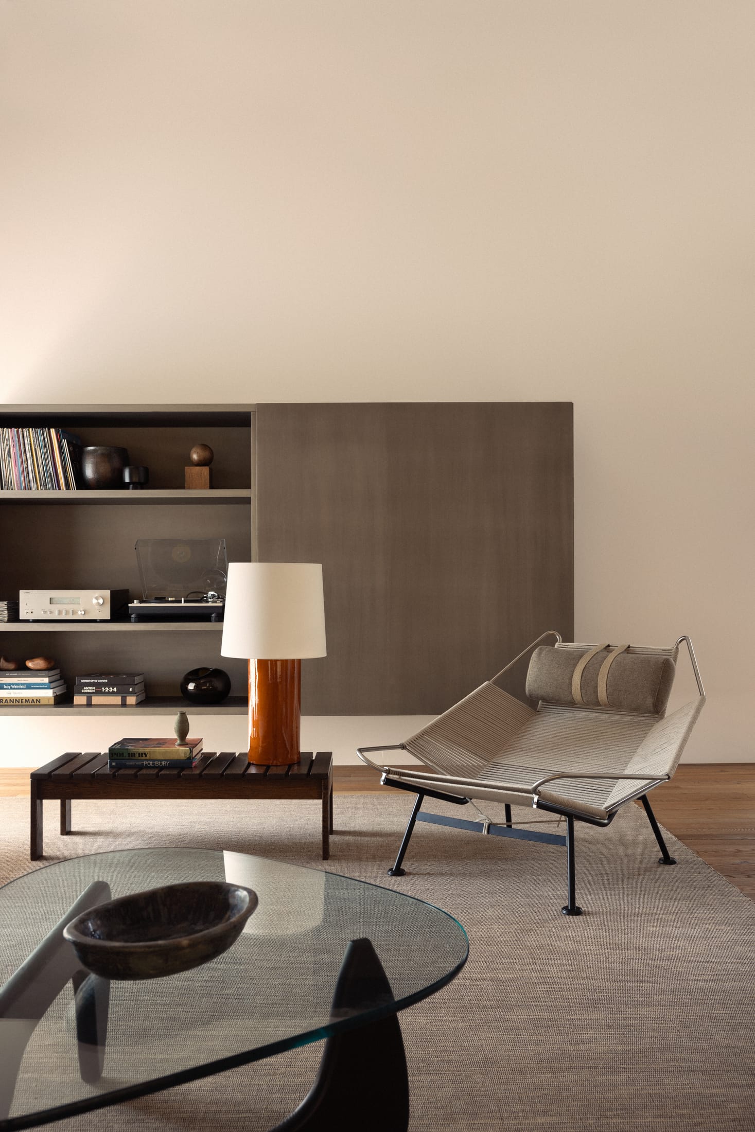 Bright open-plan living area with large windows and light wood flooring.