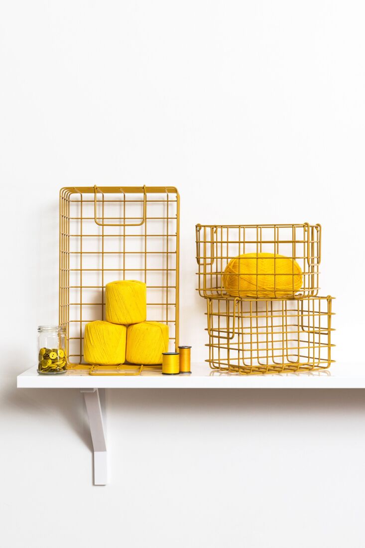 A set of wire baskets designed for locker organization in Mustard yellow.