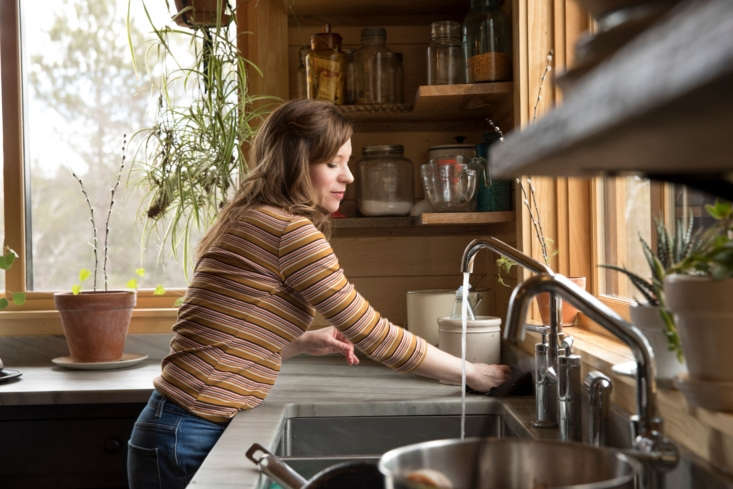 A large, professional-style triple-basin sink in a home kitchen.