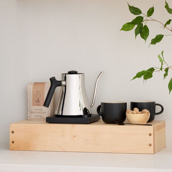 A Reds Wood Design cord box effectively concealing electrical wires on a kitchen counter.