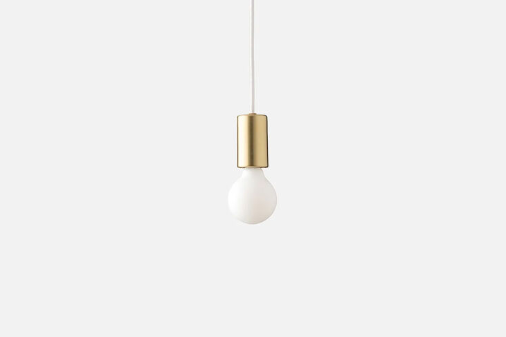 Schoolhouse Cylinder Pendant in natural brass with a sleek industrial design.