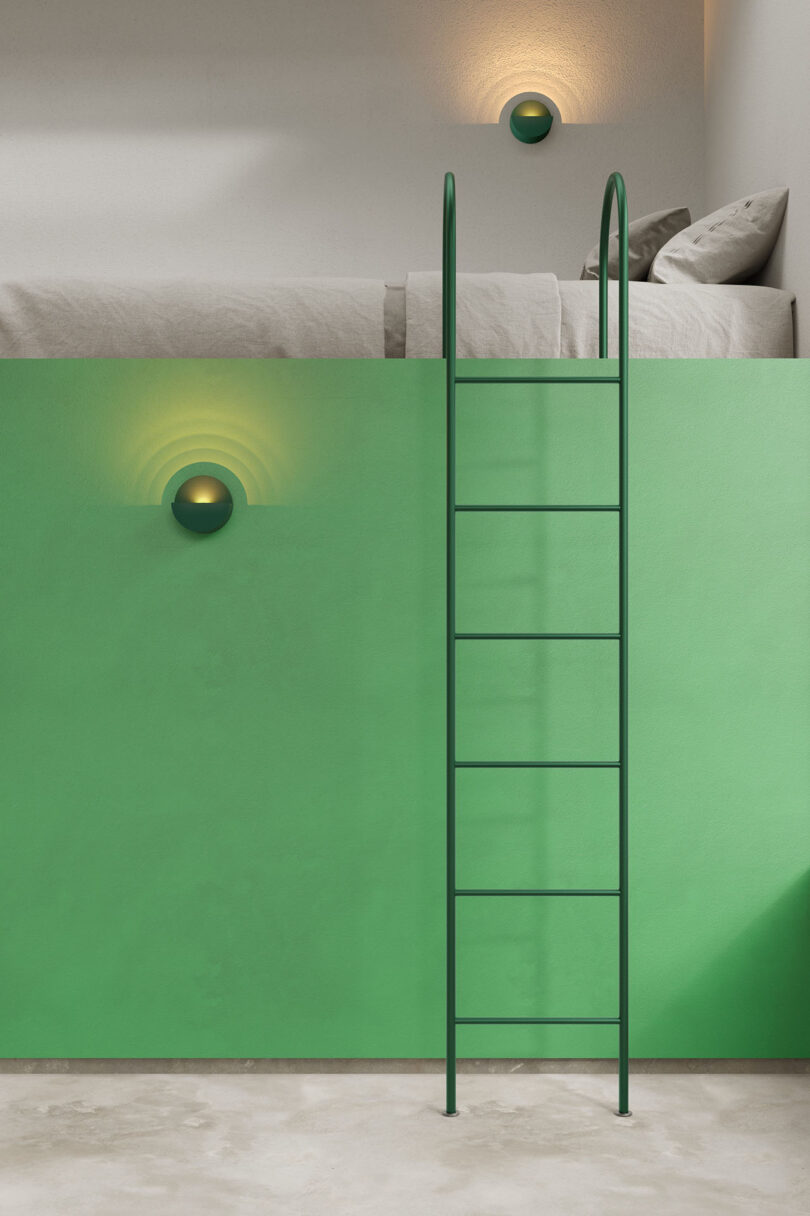 Modern bedroom with green walls and two round wall lights placed at different heights near a lofted bed.