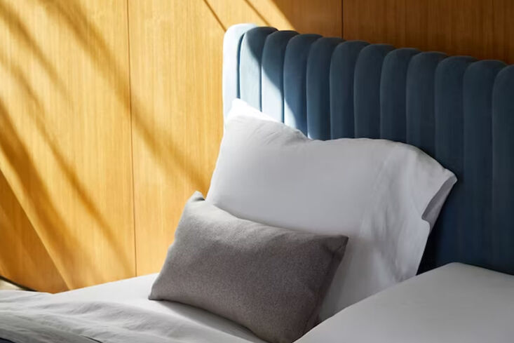 The Charlotte Headboard by Design Within Reach in a dark velvet upholstery.