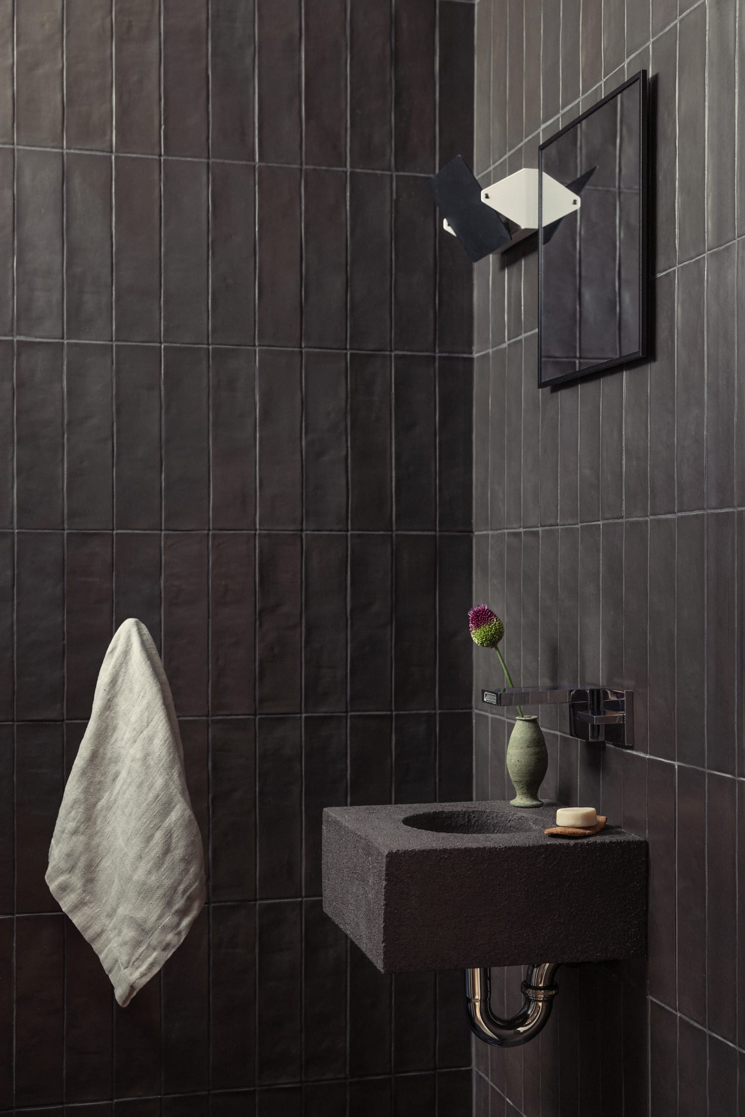 Living space featuring curved neutral-toned sofas and a minimalist coffee table.