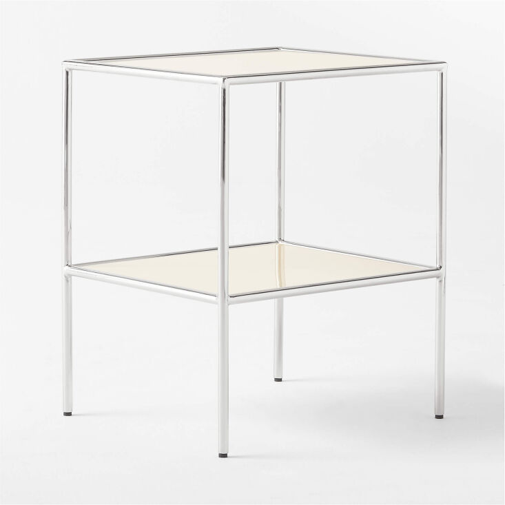 A CB2 Crain ivory enameled metal side table with a minimalist low-profile design.
