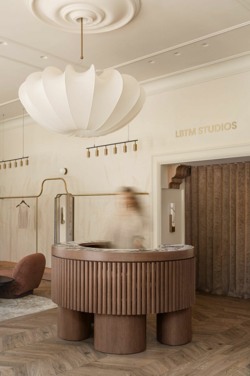 LBTM Studios reception area with a wooden desk and minimalist brand signage on a cream wall.
