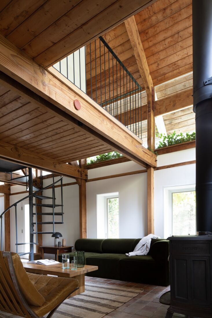 Interior view of a mezzanine level showing exposed Douglas Fir framing and pine wood paneling.