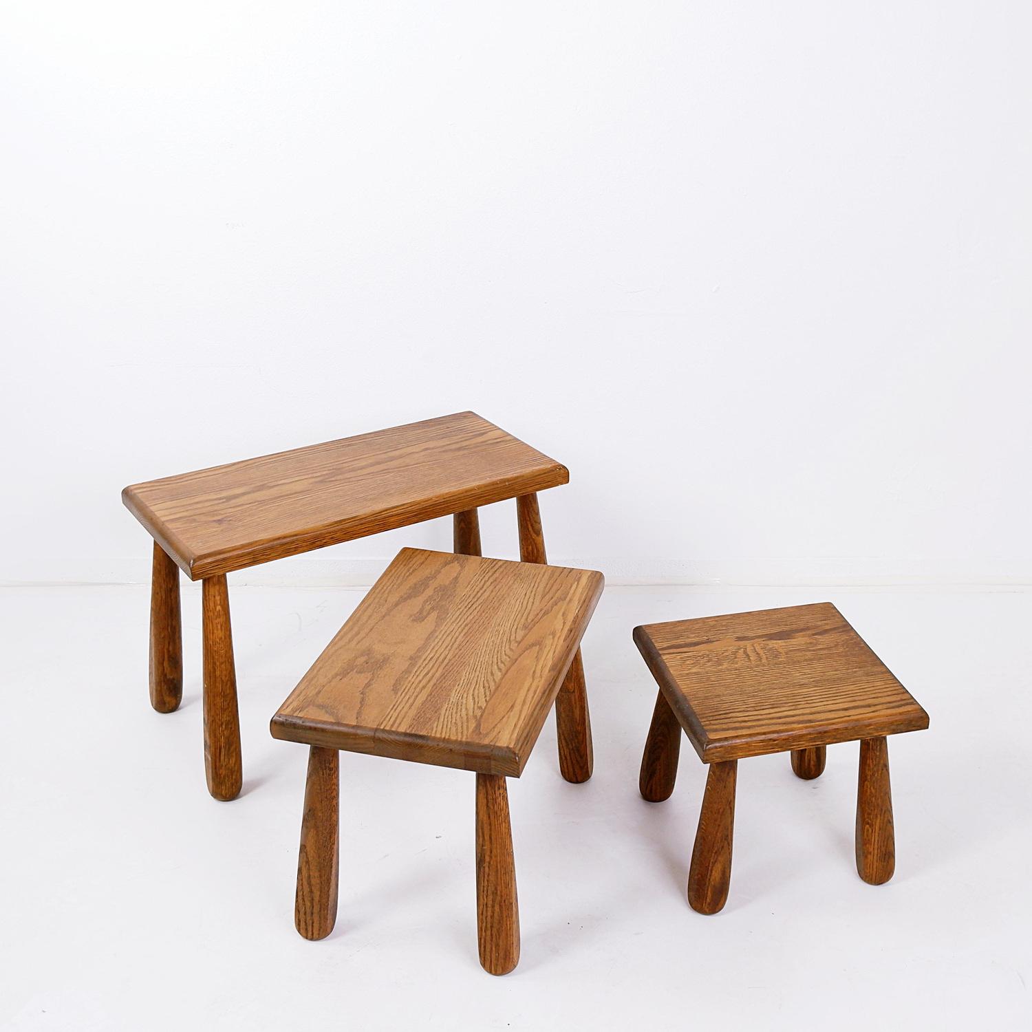 A set of three nesting tables made of solid, dark-toned Brutalist oak.