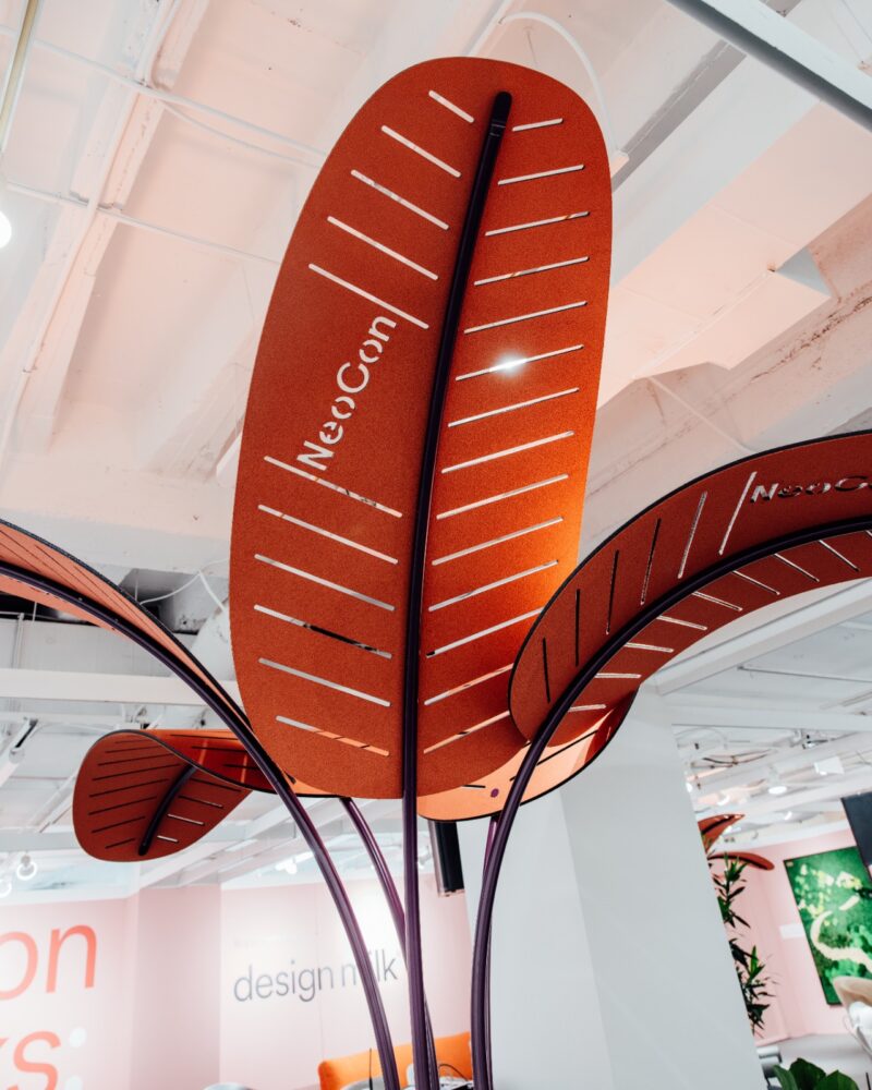 Large orange leaf-shaped acoustic panels displayed at the NeoCon pavilion.