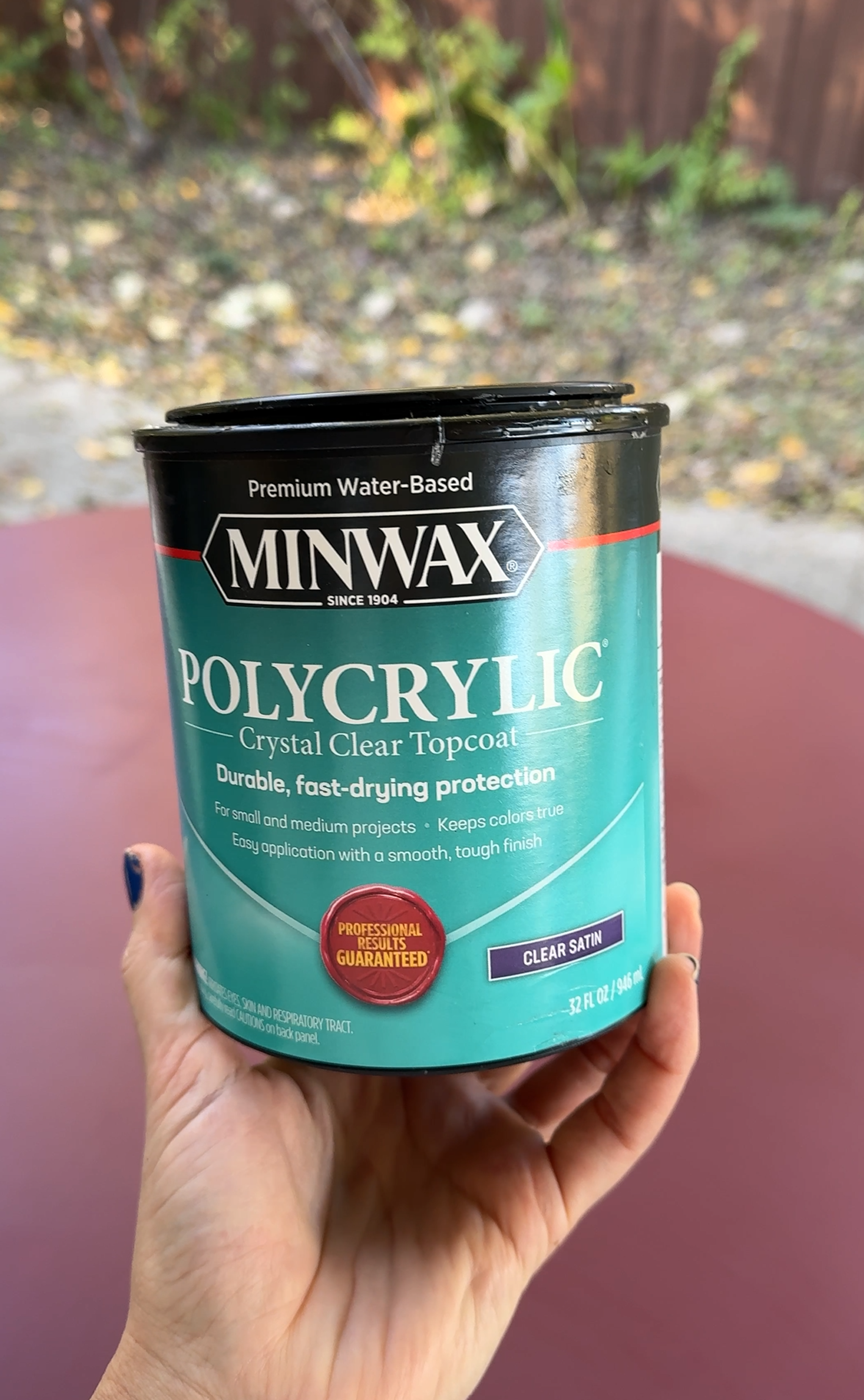 An open can of water-based polyurethane sealant with a clean brush.