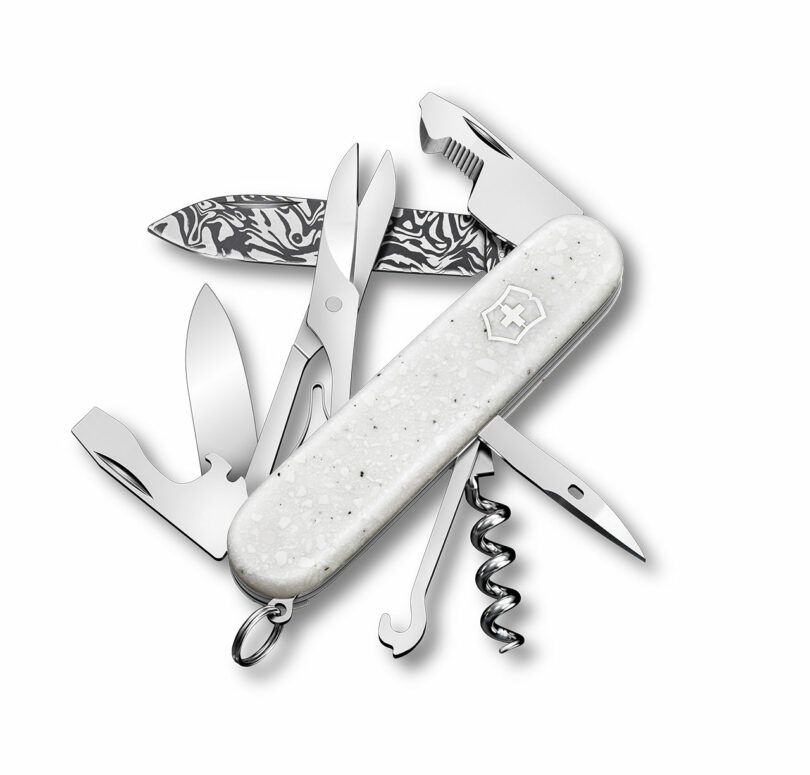 A fully opened Victorinox Swiss Army knife showing all 12 tools including scissors and various openers.