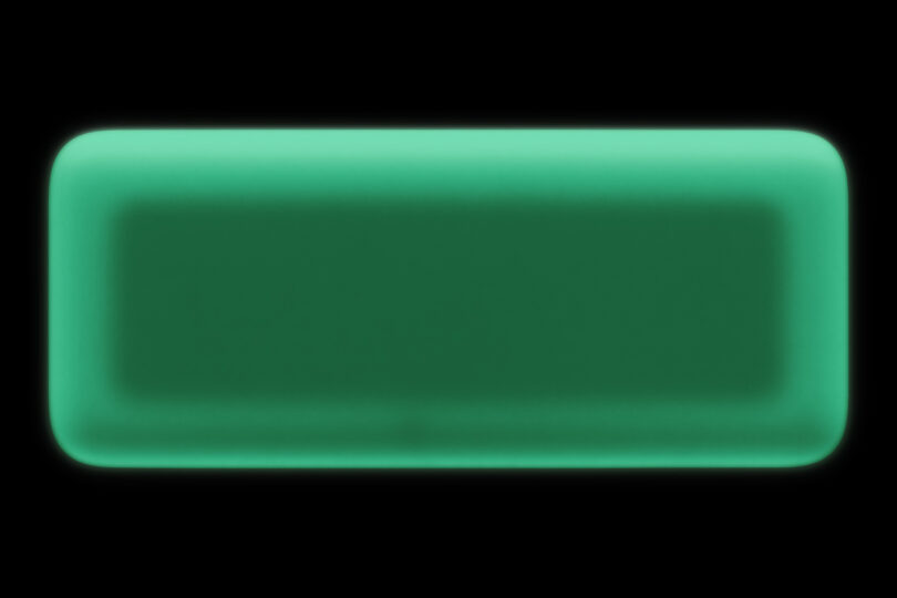 The rounded, glow-in-the-dark Dream Recorder shell illuminated in a pitch-black environment.