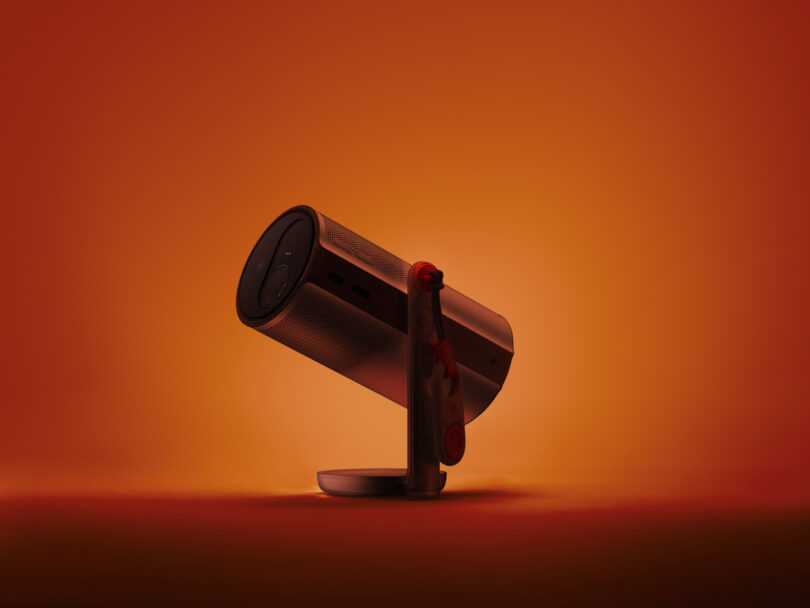 The XGIMI MoGo 4 mounted on its integrated swivel stand against a gradient background.