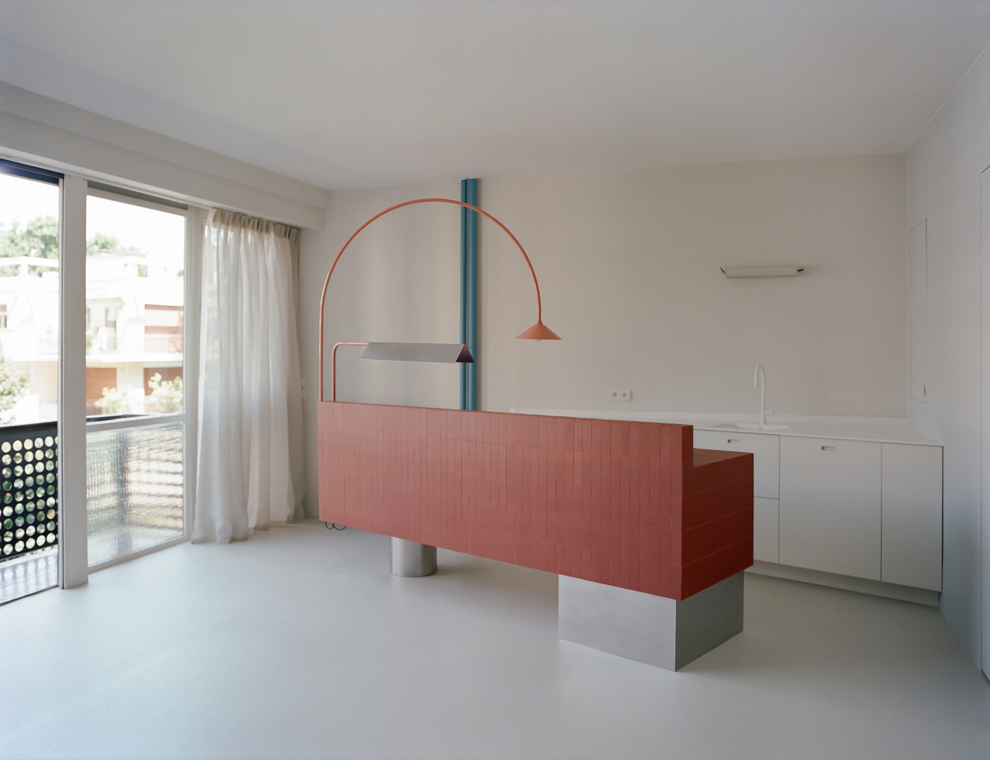A wide-angle view of the restored Le Corbusier apartment featuring minimalist furniture and large windows.