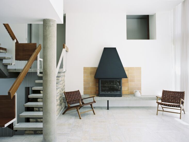 Restored living room fireplace with polished original marble floors.