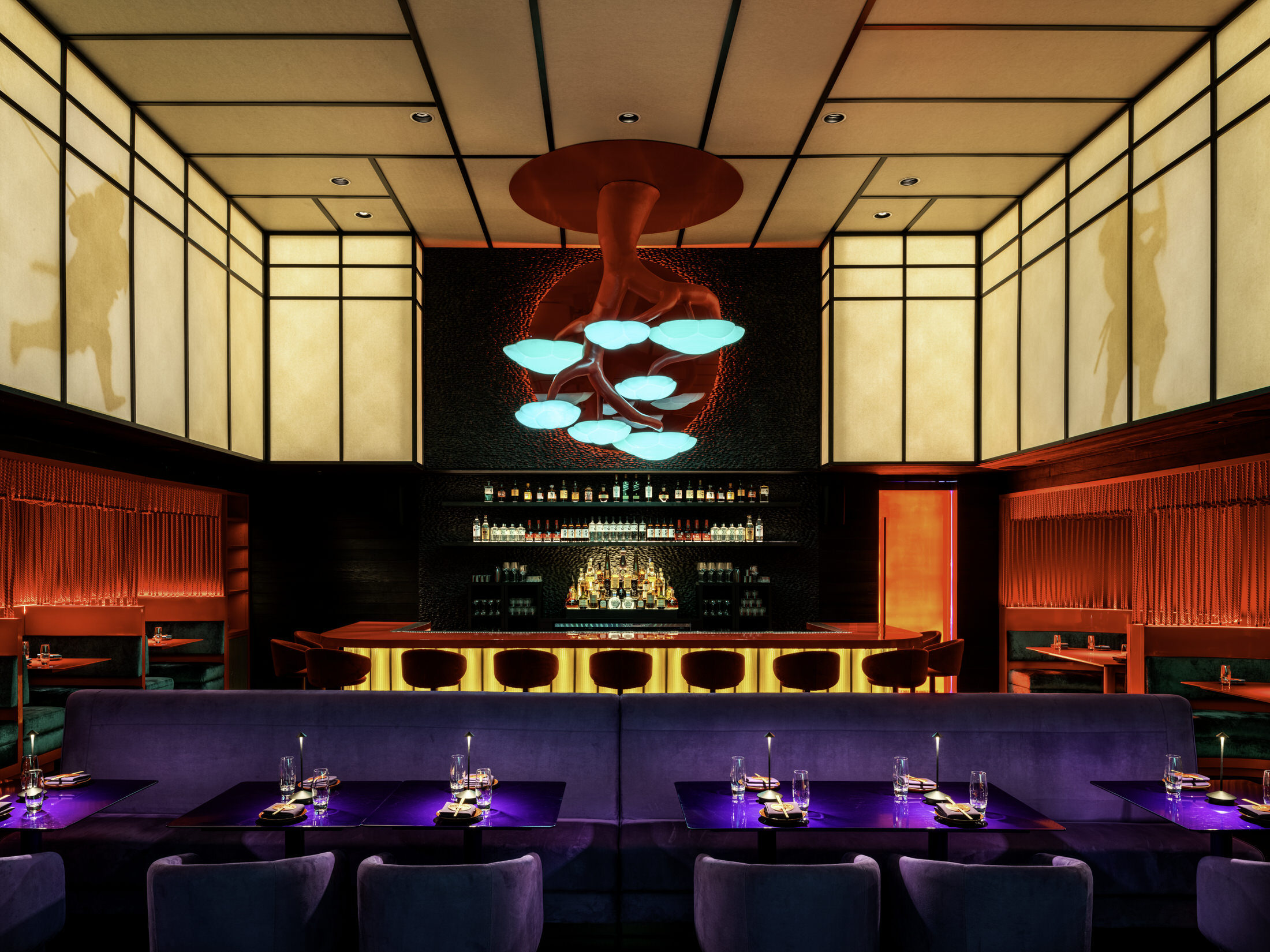 Entryway of Haii Keii featuring glowing red glass and atmospheric blue lighting.