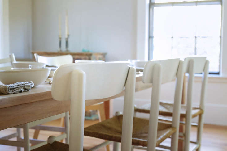 A complete set of newly painted and professionally finished dining chairs in a modern room.