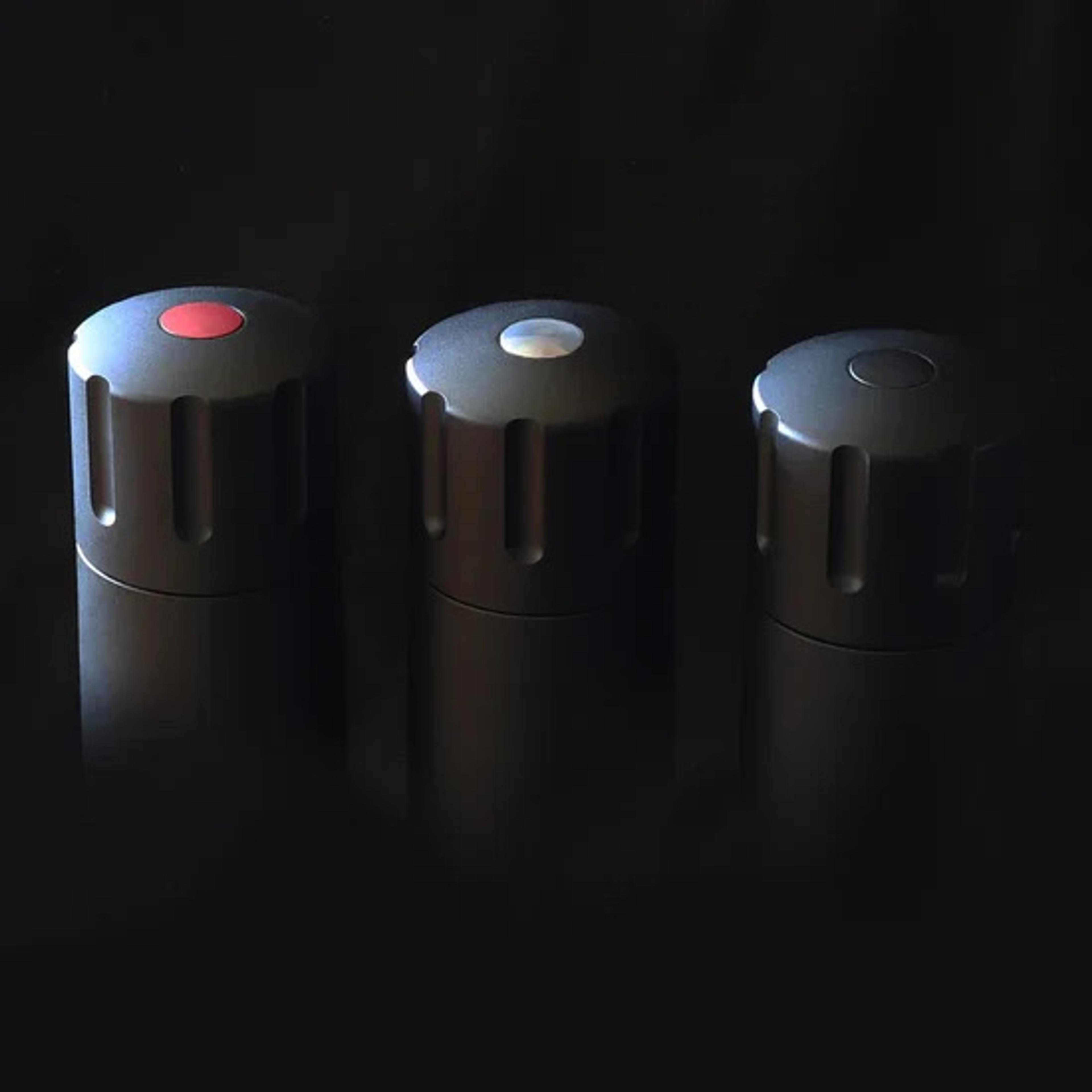 Three sleek black MÄNNKITCHEN pepper grinders standing upright.
