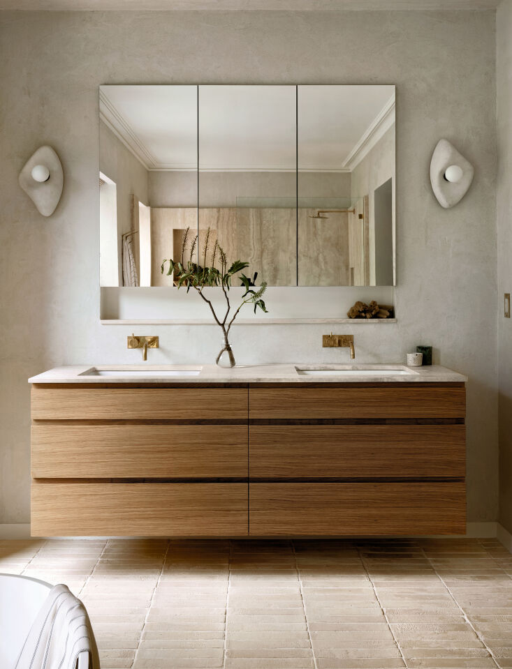 Modern bathroom vanity featuring a Navona Travertine counter and white oak cabinetry.