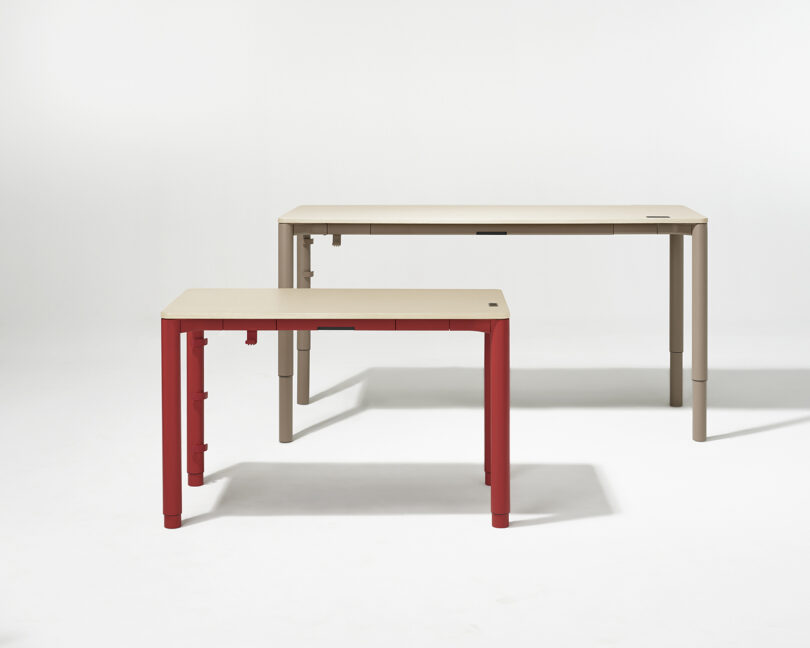 Two Spout tables shown together, one with vibrant red legs and one with neutral beige legs.