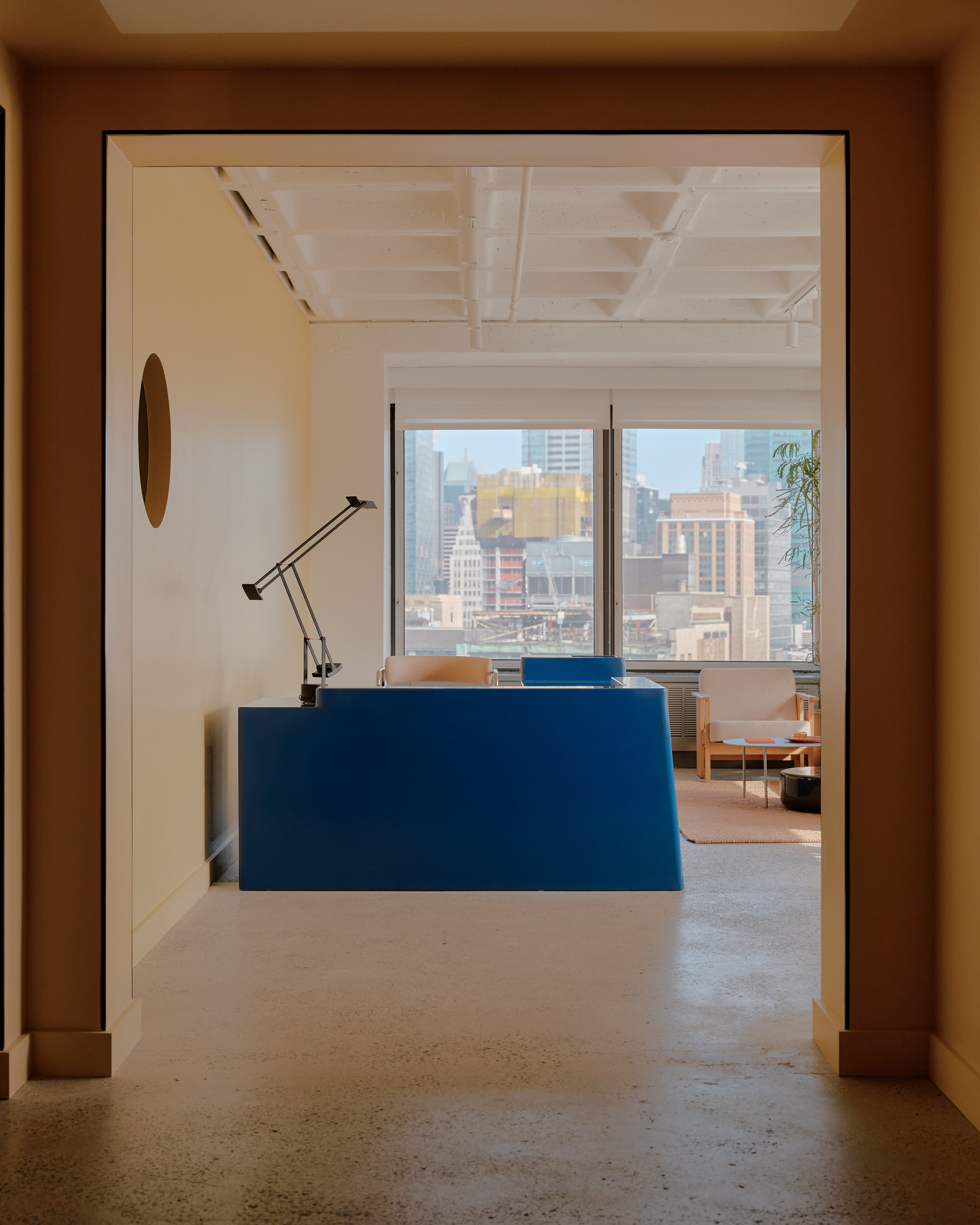 A spacious open-plan office in the NoMad building featuring historic concrete ceilings and modern workstations.