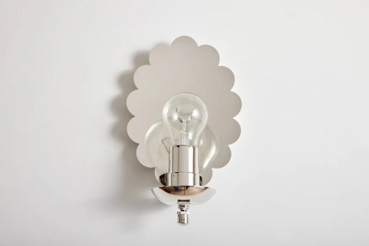 A silver-toned nickel scalloped sconce providing a cool, minimalist look.