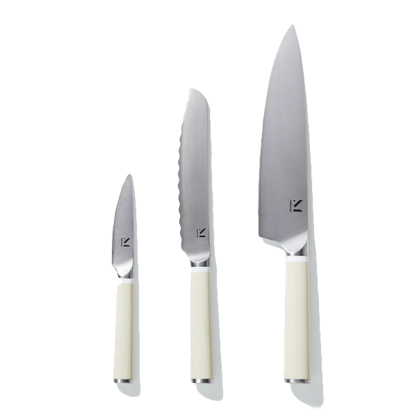 Flat lay of raw cod, fresh fennel bulbs, lemons, oranges, and herbs on a wooden surface.