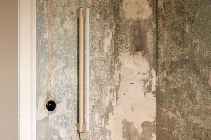 A white Frama Eiffel Wall Lamp with an industrial perforated metal design.