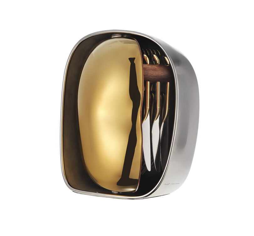 Modern metallic cutlery set with gold-colored utensils and a matching gold and silver case.