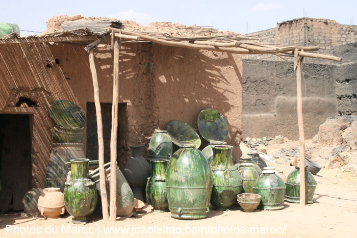 Unfinished Tamegroute pottery pieces in a workshop environment.