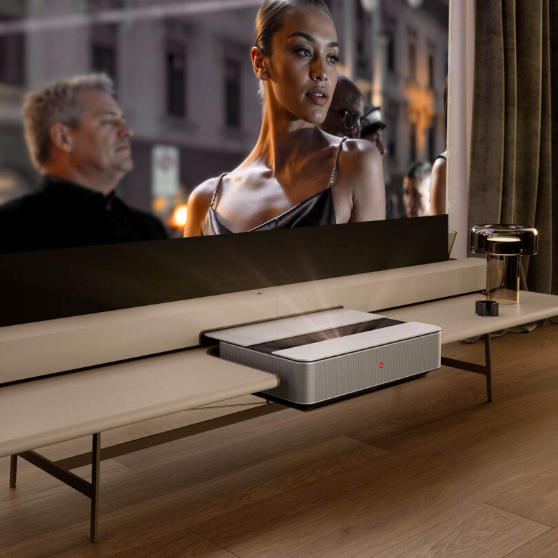 A vibrant movie scene projected onto a large screen in a well-lit modern living room.