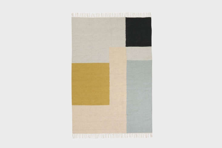 A Ferm Living Kelim Rug with geometric patterns on a light floor.