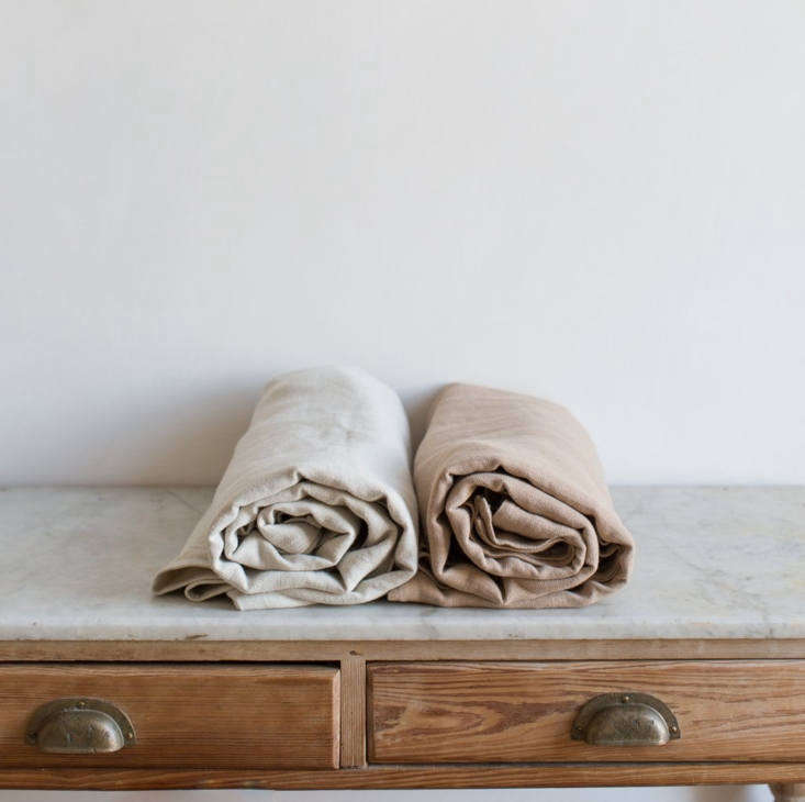 Belgian linen bedding in a muted ivory tone on a simple bed.