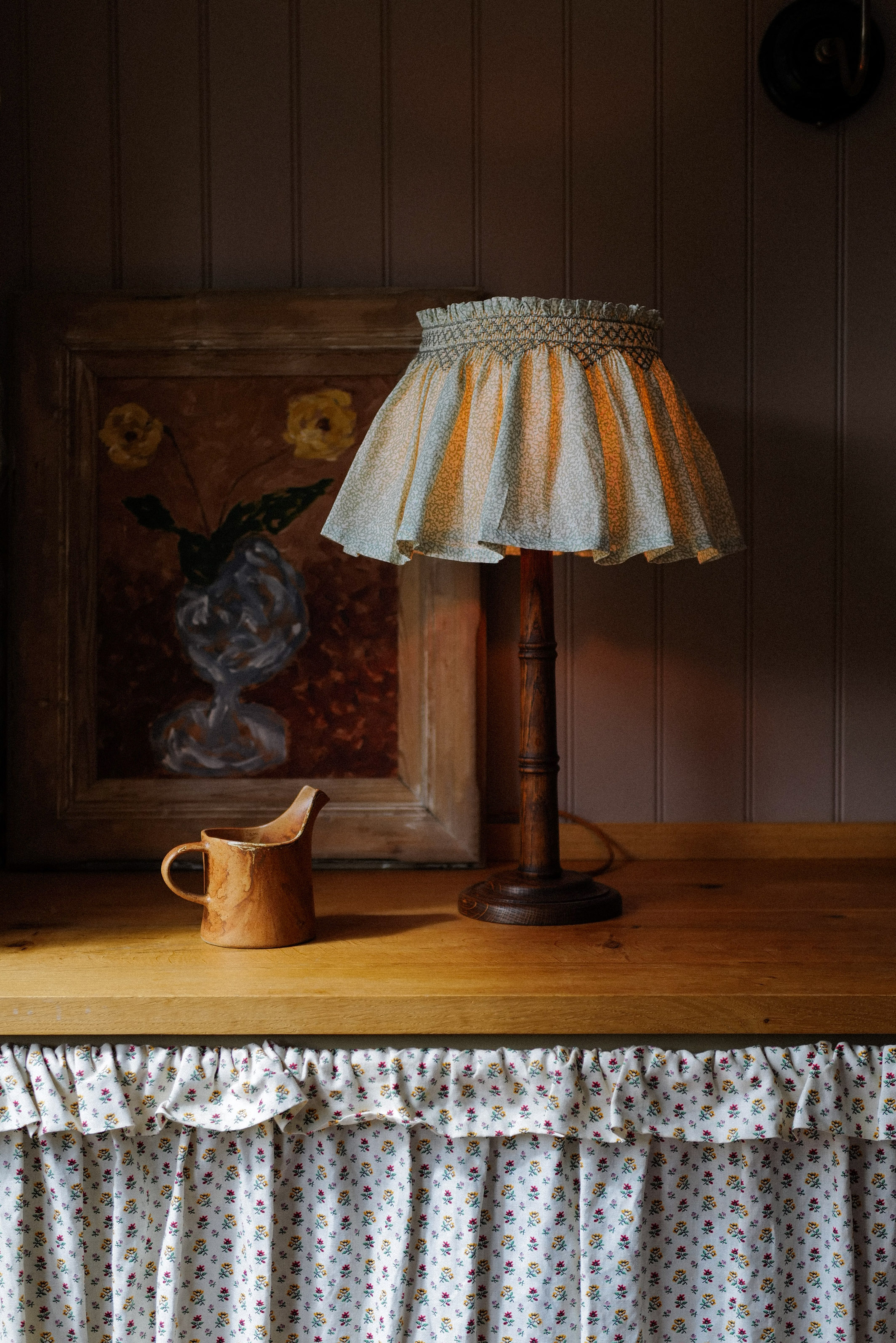 A patterned cotton smocked shade on a dark oak bamboo lamp base.