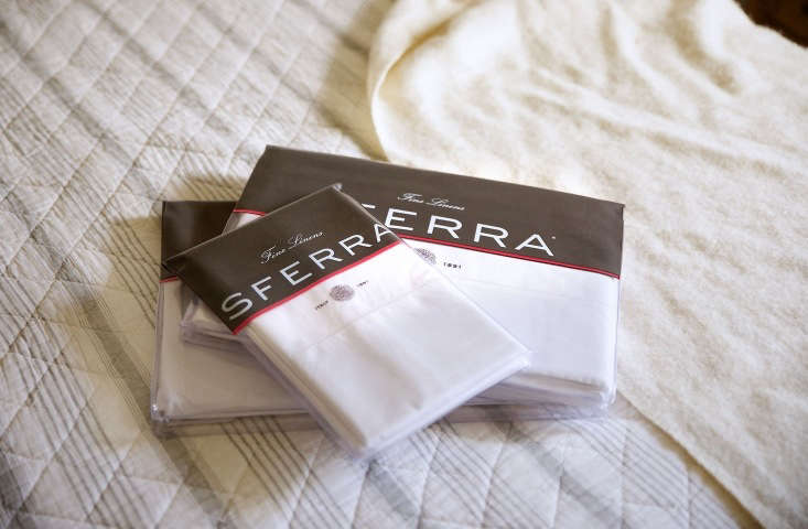 A stack of white Sferra Giza 45 Percale sheets showing a clean, matte finish.