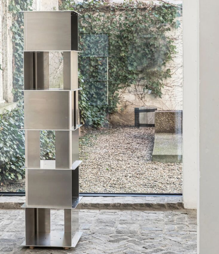 A vertical 'totem' style aluminum shelving unit from the Stack collection.