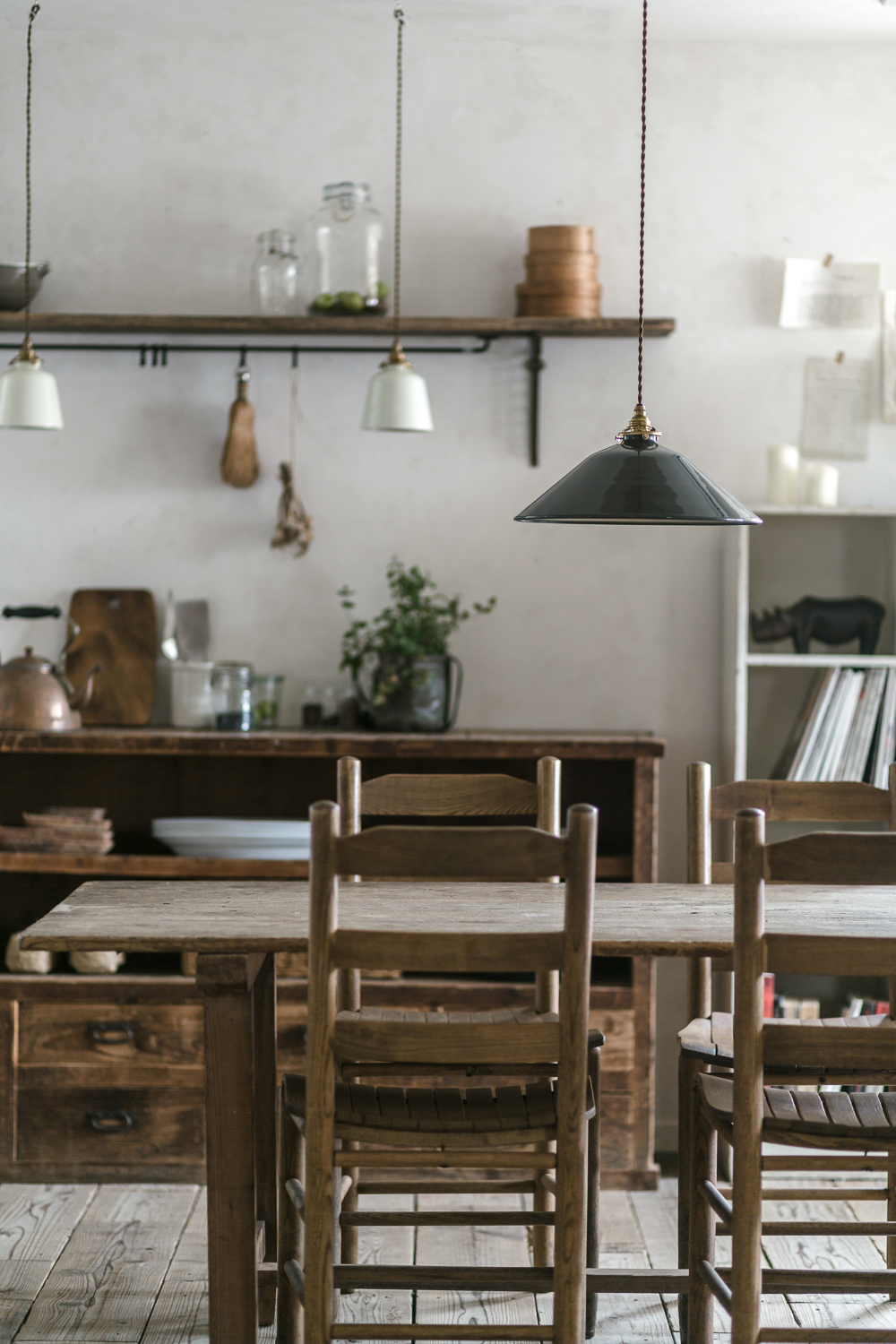 Black and white hand-enameled Basque pendant lights with twisted cloth cords.