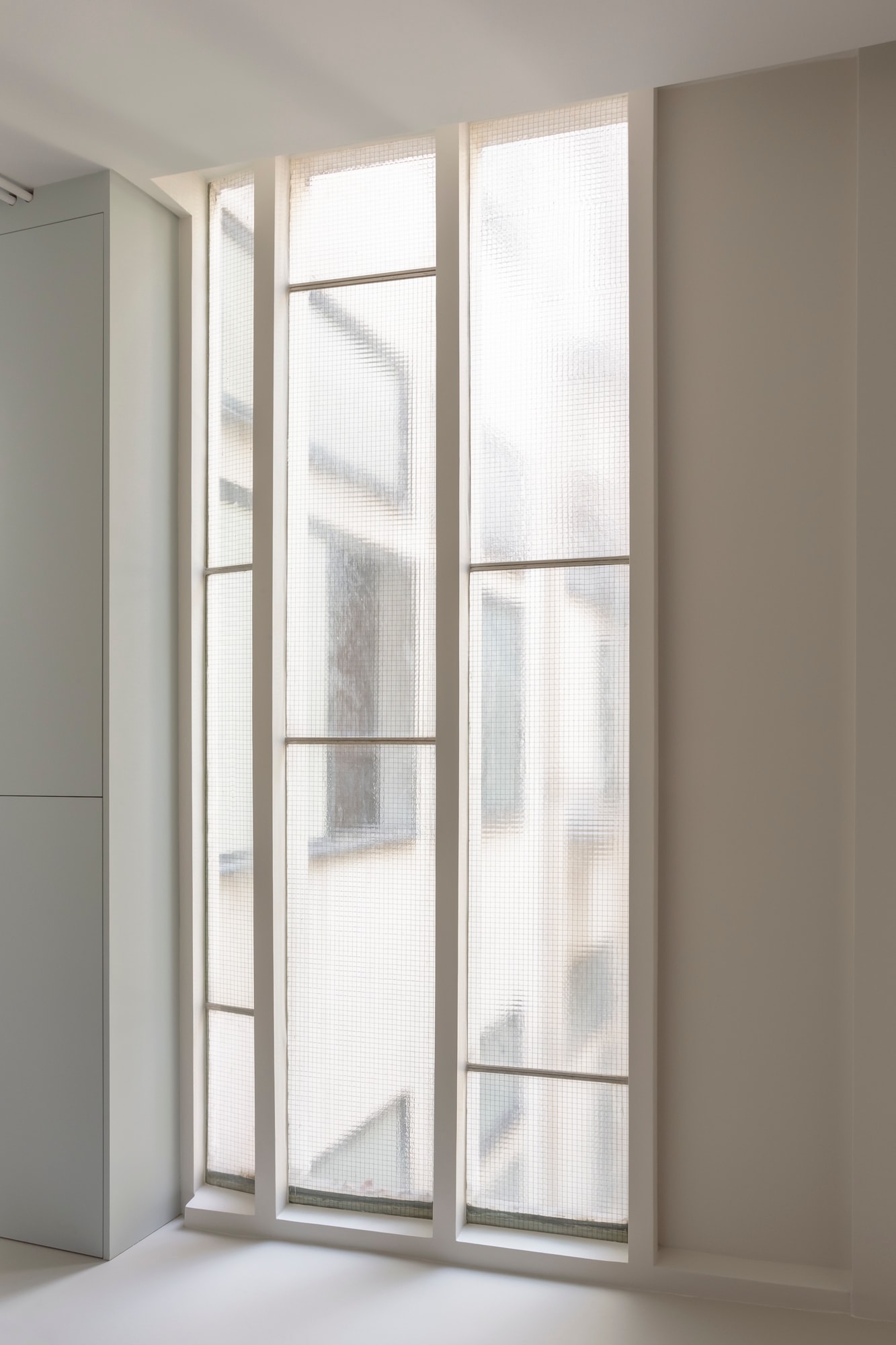 Close-up of the glass brick and steel frame windows in the Molitor apartment.