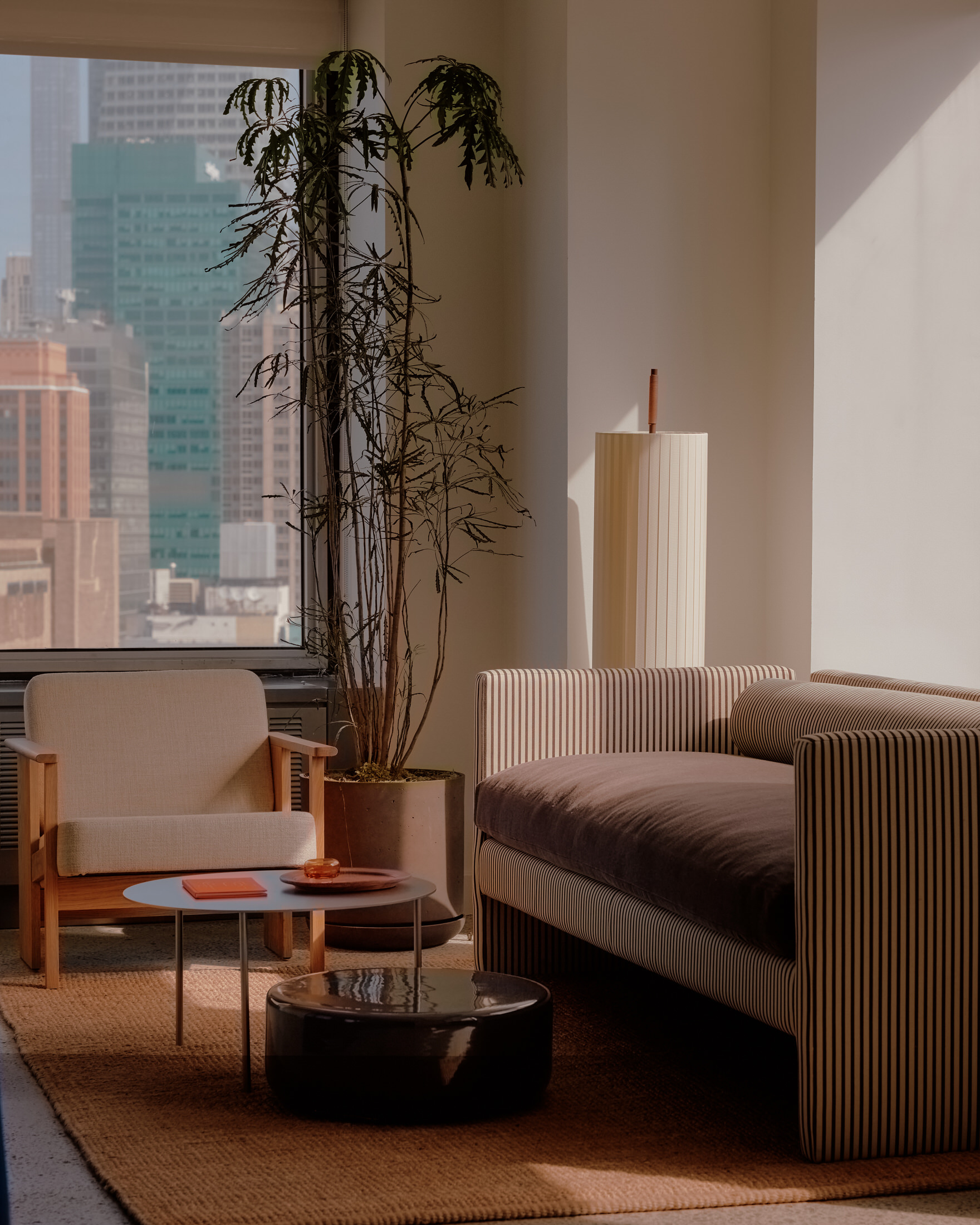 A minimalist blue reception desk against a backdrop of raw concrete and eucalyptus wood panels.