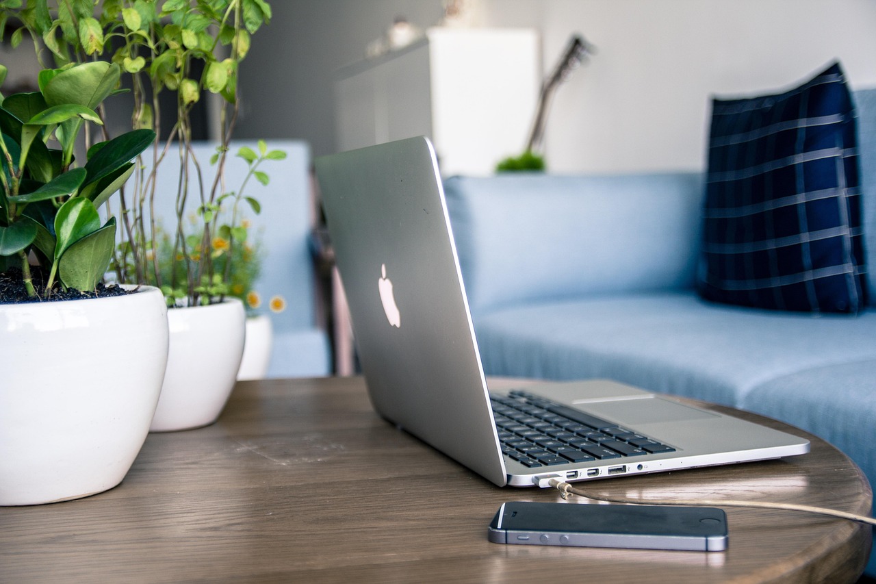 Modern clean desk with a MacBook, wireless peripherals, and minimalist lighting