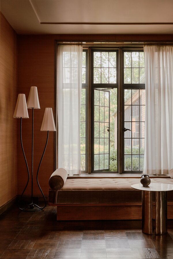 A vibrant, patterned rug placed underneath a neutral-toned daybed.
