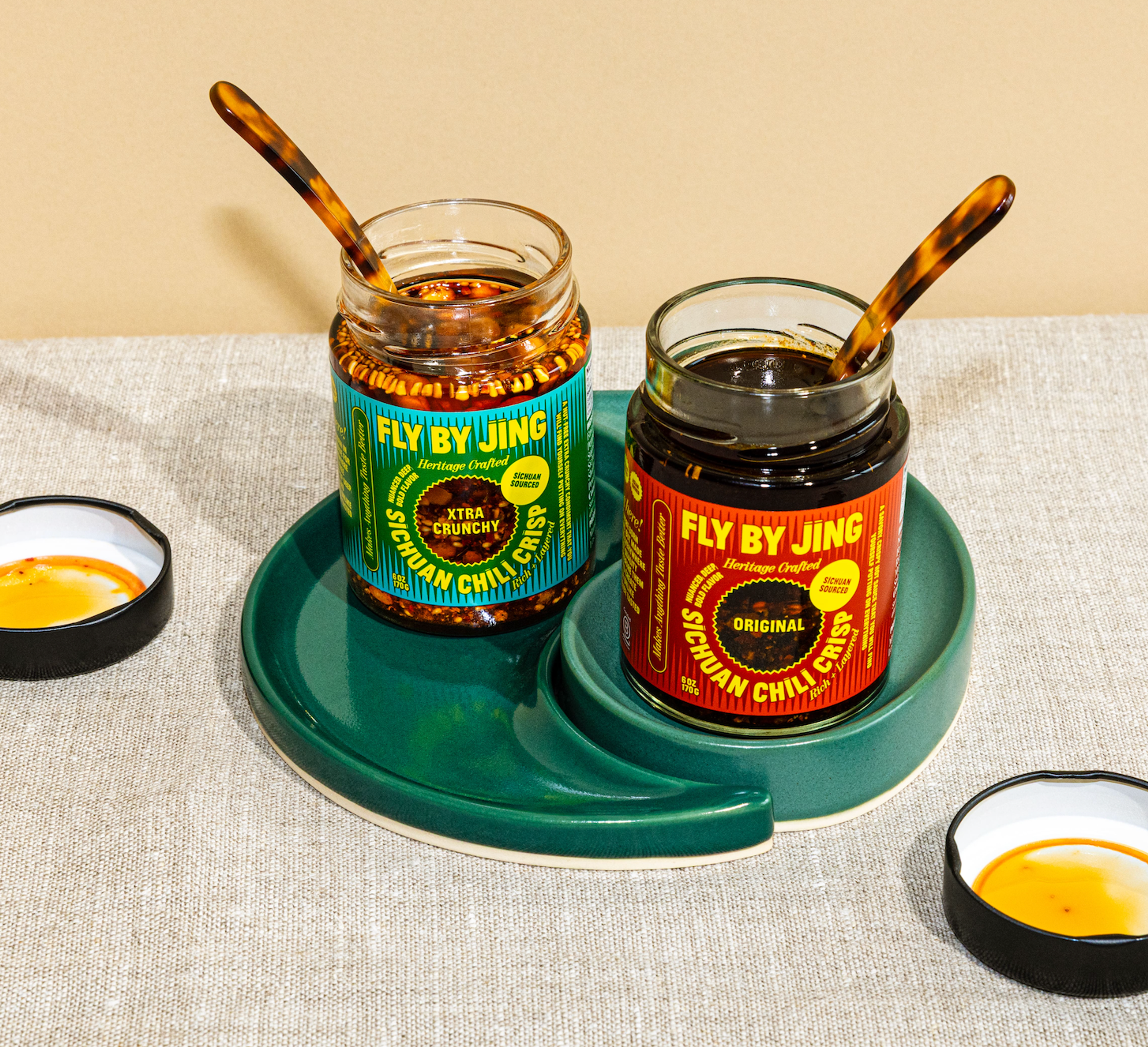 Jars of chili oil and condiments on a dining table.