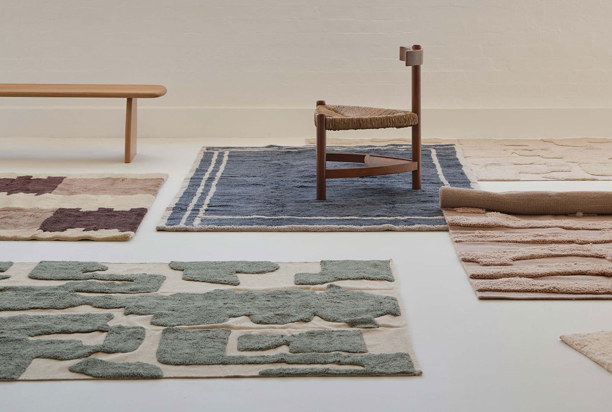 A styled living room featuring a large Wild South rug under contemporary furniture.