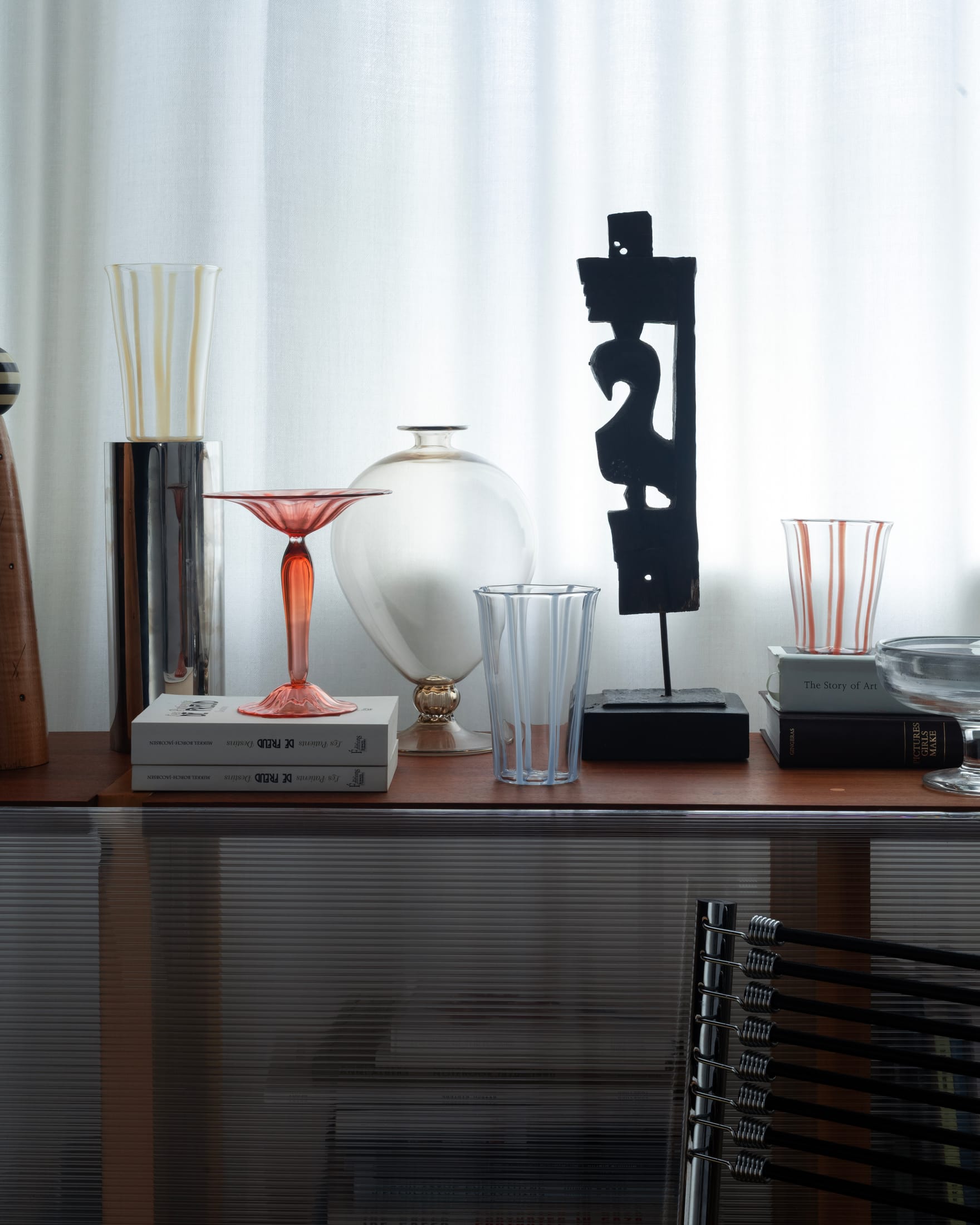 Pastel striped glassware from the Le Verre Bonbon series on a dark surface.