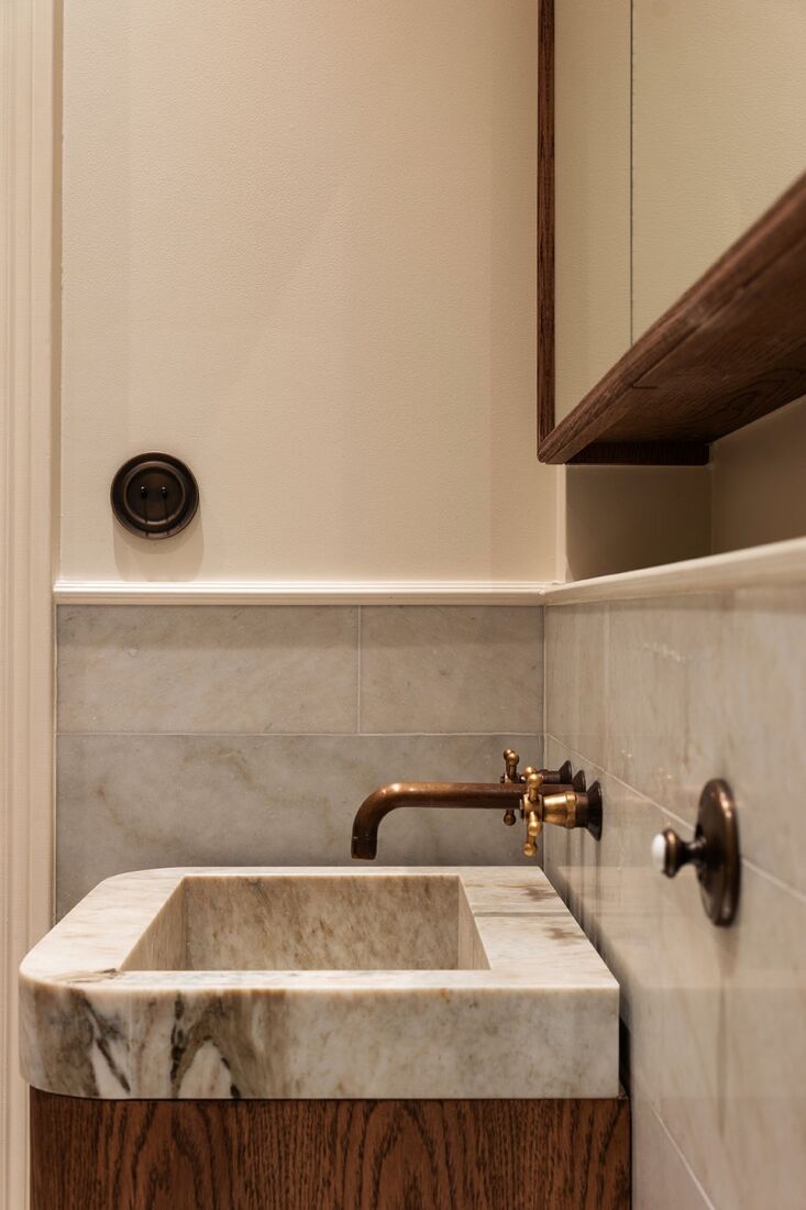 A wall-mounted Christiansborg built-in basin faucet in a minimalist bathroom setting.