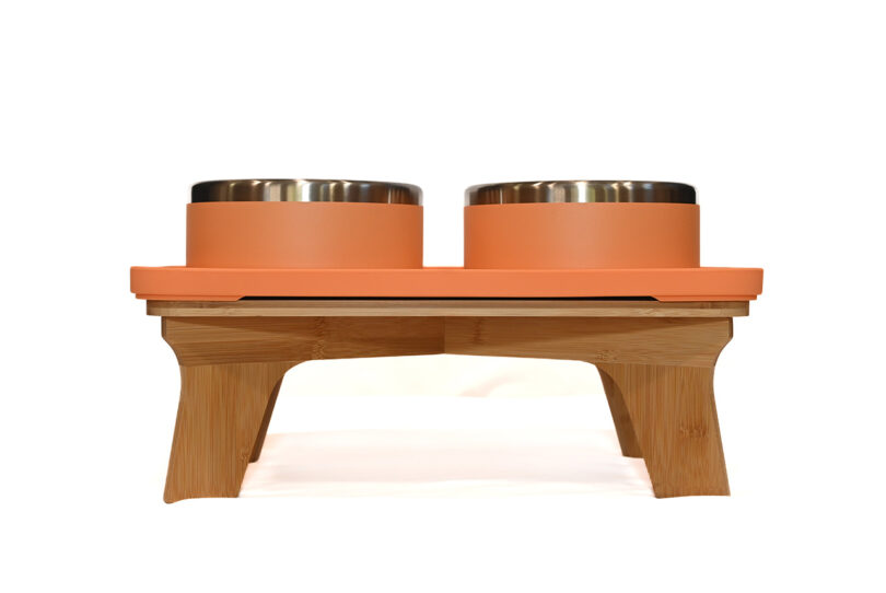 A classic wooden elevated pet feeder stand with two stainless steel bowls.