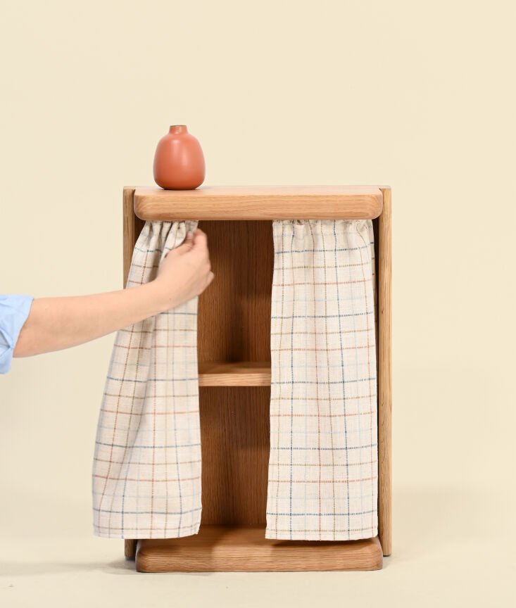 The Nook Curtain Table on legs, hiding cables behind a small fabric curtain.