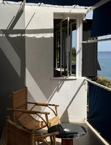 Architectural details of Villa E-1027 including white pilotis and open-air corridors.