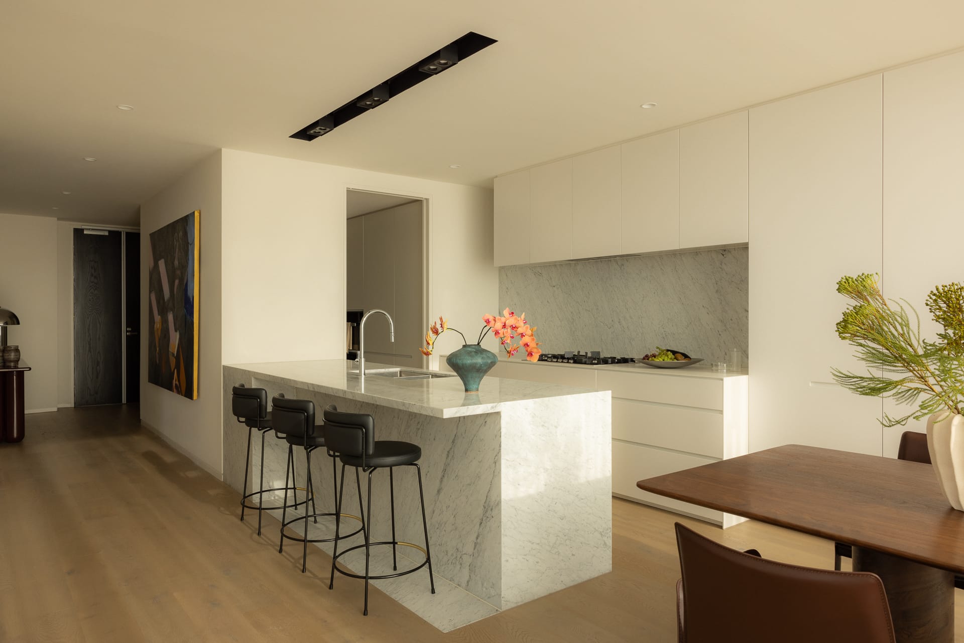 A wide shot of a multi-functional living and dining area with sculptural furniture defining different zones.
