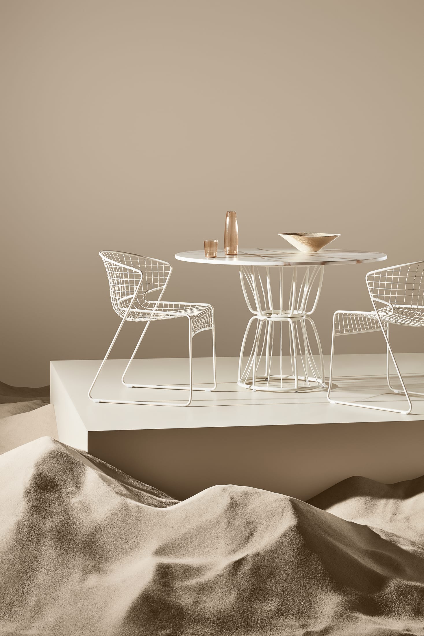 Artistic shot of a Nautiloid chair highlighting the interplay of light and shadow through its metal grid.